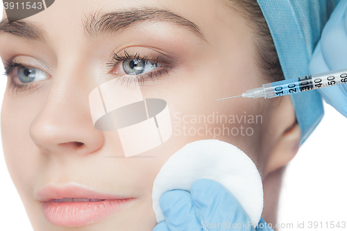 Image of Attractive woman at plastic surgery with syringe in her face