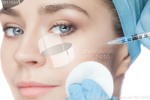 Image of Attractive woman at plastic surgery with syringe in her face