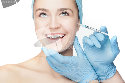 Image of Attractive woman at plastic surgery with syringe in her face