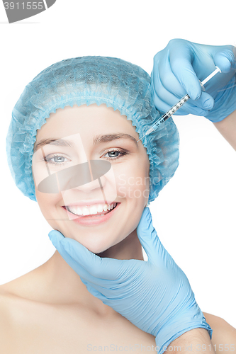 Image of Attractive woman at plastic surgery with syringe in her face