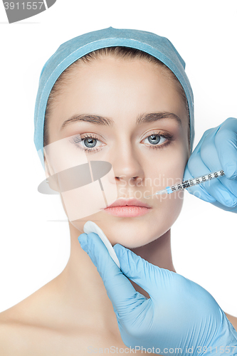 Image of Attractive woman at plastic surgery with syringe in her face