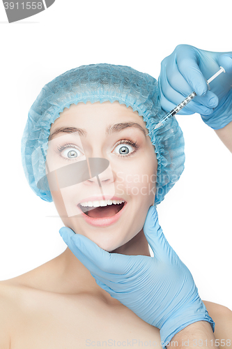 Image of Attractive woman at plastic surgery with syringe in her face