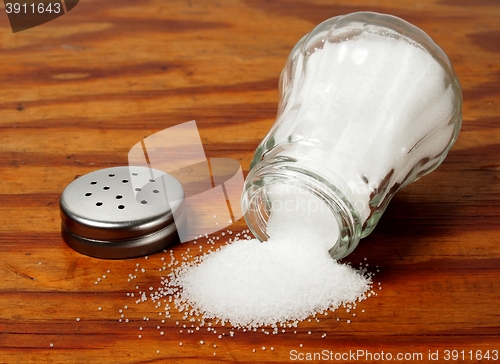 Image of Salt shaker on wooden table