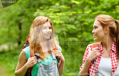 Image of group of smiling friends with backpacks hiking