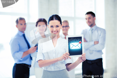 Image of businesswoman holding tablet pc with email sign