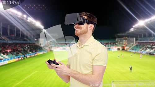 Image of man in virtual reality headset over football field