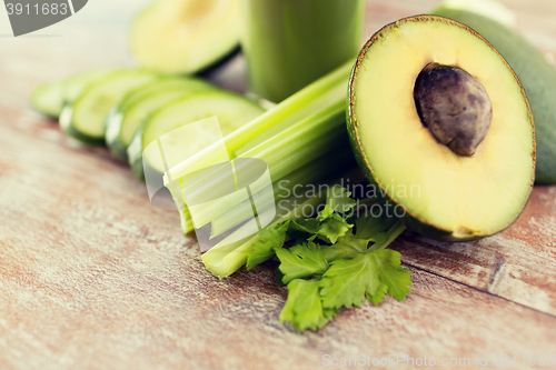 Image of close up of fresh green juice glass and vegetables