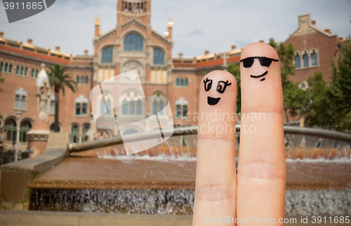 Image of close up of two fingers with smiley faces