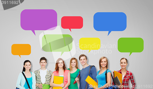 Image of group of teenage students with folders and bags