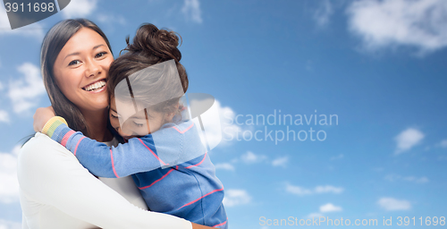 Image of hugging mother and daughter over sky background