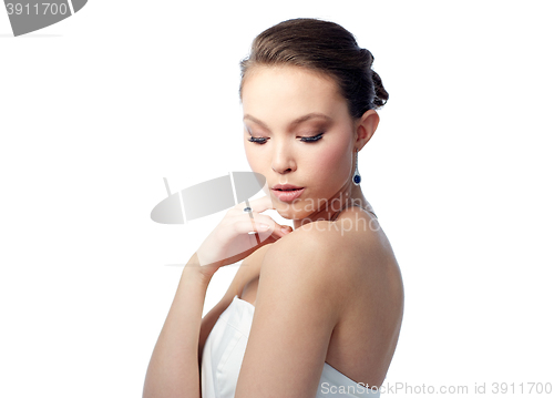 Image of beautiful woman with earring, ring and pendant