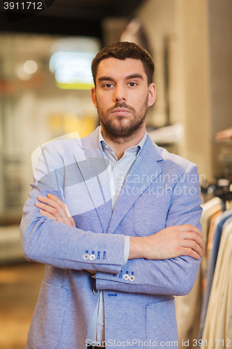 Image of young handsome man in jacket at clothing store