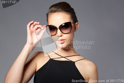 Image of beautiful young woman in elegant black sunglasses