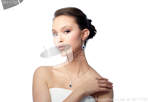 Image of beautiful asian woman with earring and pendant