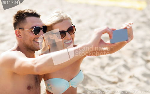 Image of happy couple in swimwear walking on summer beach