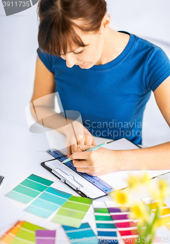 Image of woman working with color samples for selection