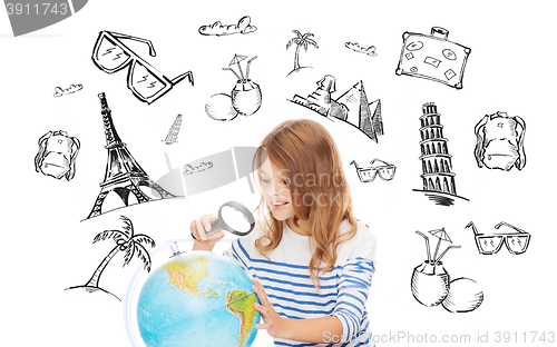 Image of student girl looking at globe with magnifier