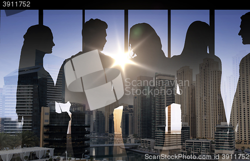 Image of people silhouettes over city background