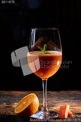 Image of Orange carrot smoothie in glass decorated mint