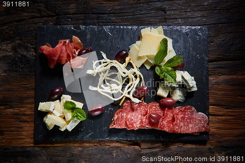 Image of Salami and cheese platter with herbs