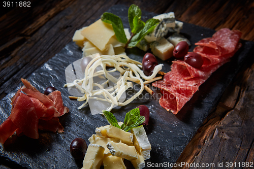 Image of Salami and cheese platter with herbs