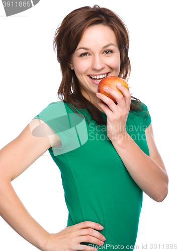 Image of Young happy girl with apple