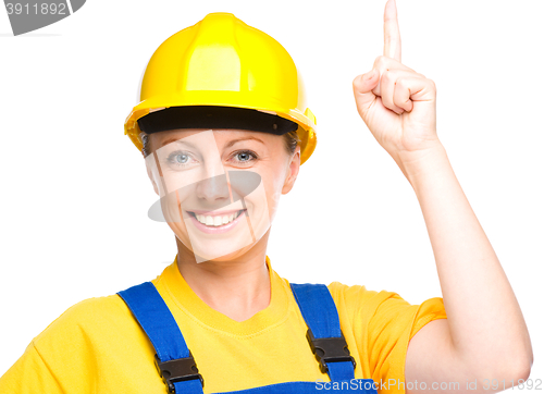 Image of Young construction worker pointing up