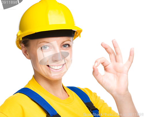 Image of Young construction worker is showing OK sign