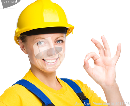 Image of Young construction worker is showing OK sign