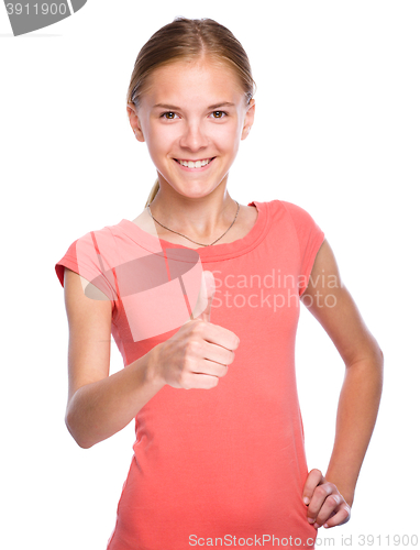 Image of Young girl is showing thumb up gesture