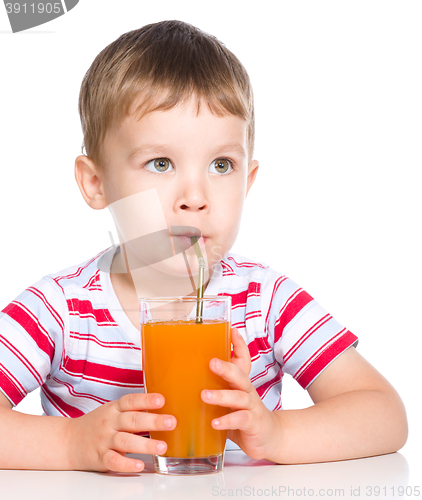 Image of Little boy with glass of carrot juice