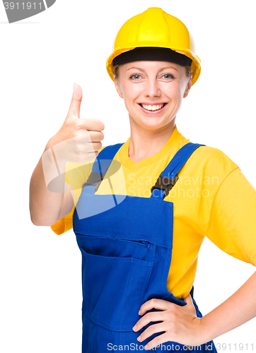 Image of Young construction worker is showing thumb up sign