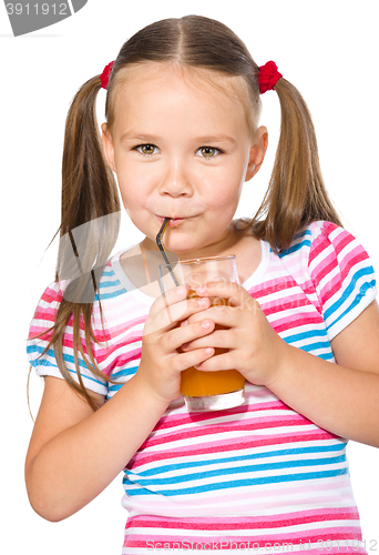 Image of Little girl is drinking carrot juice