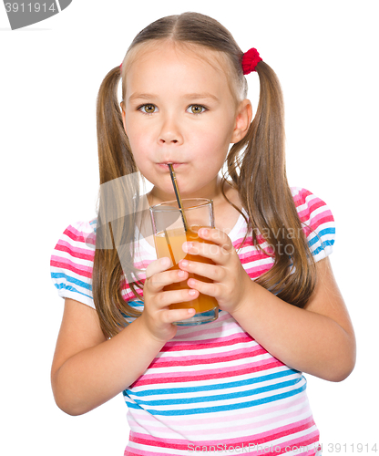 Image of Little girl is drinking carrot juice