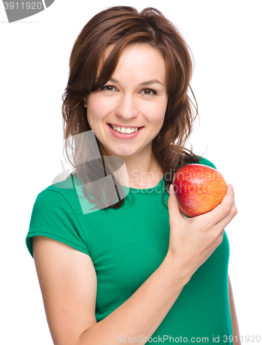 Image of Young happy girl with apple