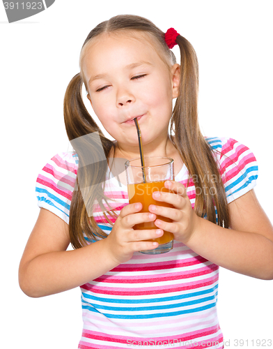 Image of Little girl is drinking carrot juice