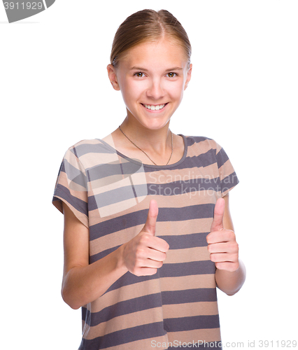 Image of Young girl is showing thumb up gesture