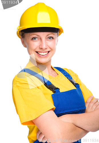 Image of Young happy lady as a construction worker
