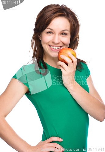 Image of Young happy girl with apple