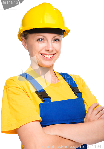 Image of Young happy lady as a construction worker