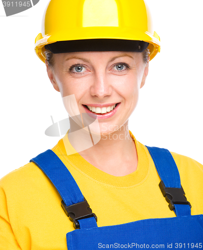 Image of Young happy lady as a construction worker