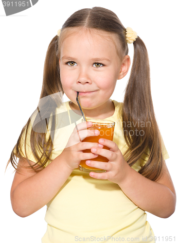 Image of Little girl is drinking carrot juice