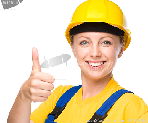 Image of Young construction worker is showing thumb up sign