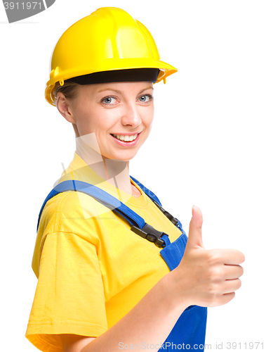 Image of Young construction worker is showing thumb up sign