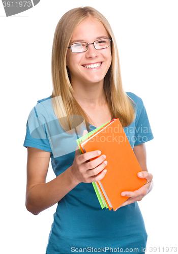 Image of Young student girl is holding book