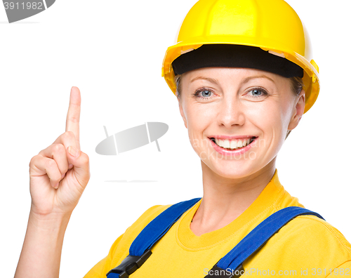 Image of Young construction worker pointing up