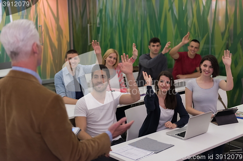 Image of students group raise hands up