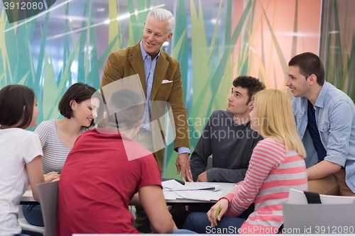 Image of teacher with a group of students in classroom