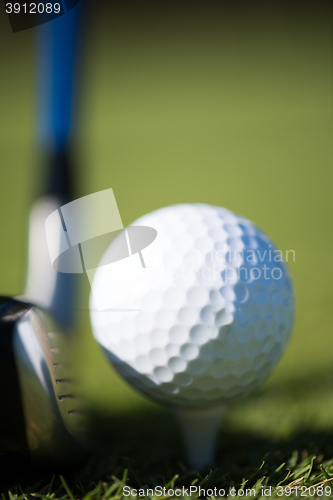 Image of golf club and ball in grass