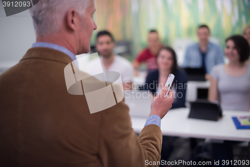 Image of teacher with a group of students in classroom